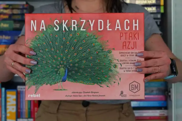 Gra "Na skrzydłach: Ptaki Azji" z pawiem na okładce. Dodatki do gry z ptakami Azji i kartami bonus.