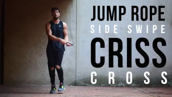 A man in athletic wear performs a jump rope routine, showcasing a "Criss Cross" move. He's as agile as Mike Tyson in his prime, mastering the jump rope.