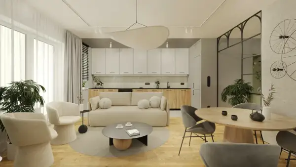 Nowoczesny salon z aneksem kuchennym, jasna sofa, okrągły stół, designerskie fotele i rośliny.