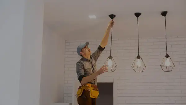 Elektryk montuje lampę sufitową. Sprawdź, jaka jest cena montażu lampy sufitowej.