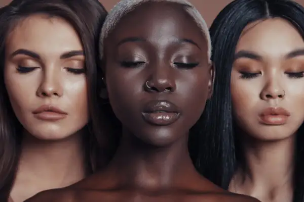 Tre donne con diverse tonalità di pelle, occhi chiusi, un'ispirazione per come avere la pelle perfetta in una settimana.