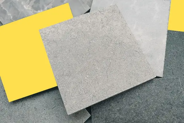 Variedad de muestras de revestimiento mineral gris y un cuadrado amarillo brillante.