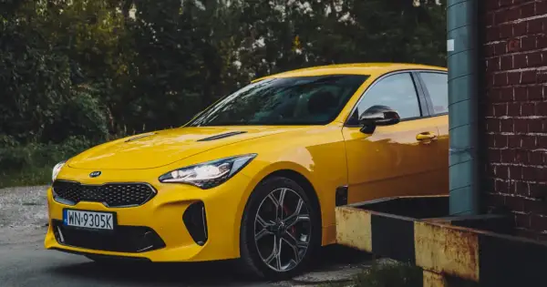 Żółty Kia Stinger, jeden z tych trudnych marek samochodów, które zaskakują osiągami.