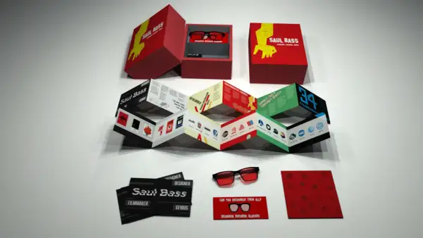 A Saul Bass designs kit, featuring a box with glasses, a folded booklet showcasing his iconic work, and cards.