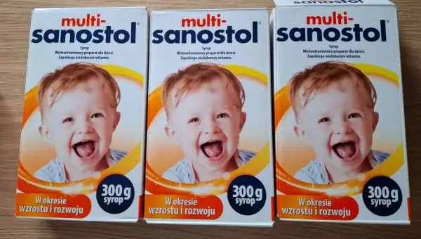 Trzy opakowania multi-sanostol wycofany, z uśmiechniętym dzieckiem, na syrop dla dzieci.
