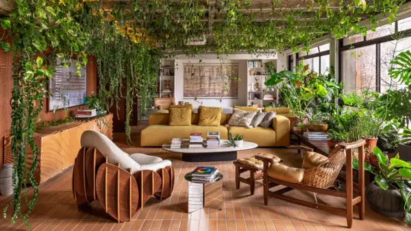 A living room embracing organic architecture, with lush plants cascading from the ceiling and filling the space, creating a vibrant, natural sanctuary.