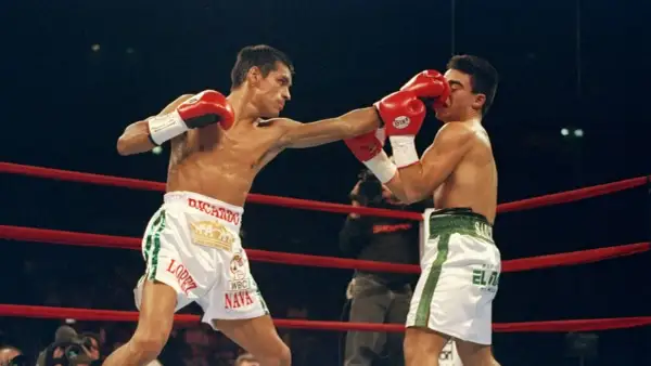 Ricardo "El Finito" Lopez lands a punch on his opponent during a boxing match.