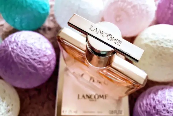 Elegancki flakon Lancome Idole 100ml otoczony pastelowymi kulkami.