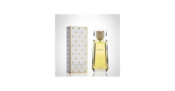 Eleganckie perfumy Carolina Herrera w złotym flakonie i pudełku w kropki.