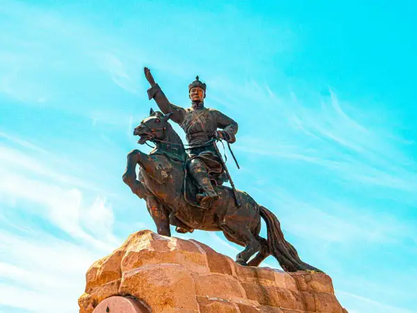 Statue équestre d'un guerrier, symbole de la descendance de Gengis Khan, sous un ciel bleu éclatant.
