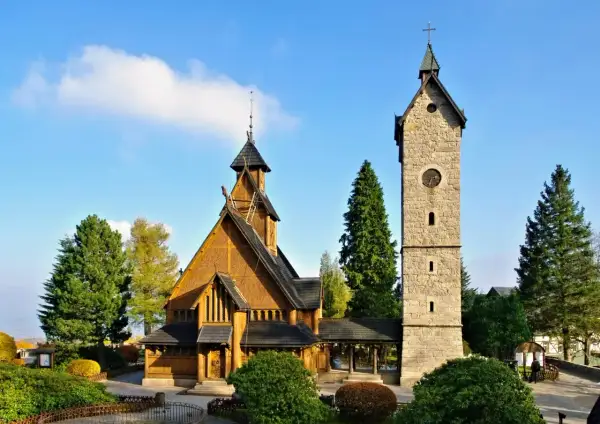 Drewniany kościółek i kamienna wieża w Karpaczu. Wspaniałe atrakcje turystyczne Karkonoszy, które warto zobaczyć.