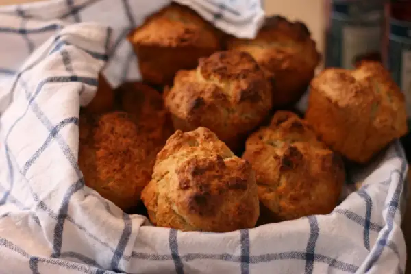 En korg med nybakade scones, perfekt för fika. Sconesdegen har fått en gyllene färg.