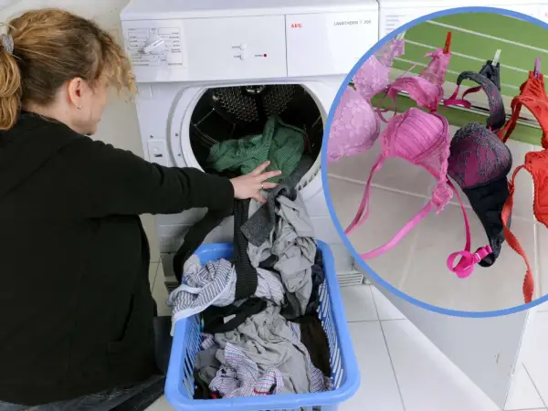 Frau lädt Wäsche in den Trockner. BHs trocknen an der Leine.
