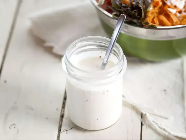 Frisches Joghurt Dressing selber machen ist einfach! Hier ein Glas mit cremiger, selbstgemachter Joghurt-Dressing-Basis, bereit für den Salat.