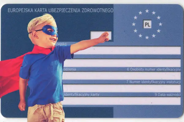 Mały superbohater w masce i pelerynie na tle Europejskiej Karty Ubezpieczenia Zdrowotnego. To ekuz dla dziecka, które jest gotowe na każdą przygodę!
