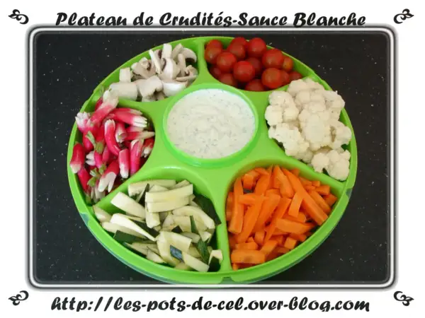 Plateau de crudités coloré : radis, champignons, tomates cerises, chou-fleur, courgettes et carottes, avec une sauce blanche au centre.