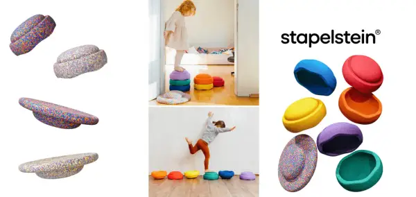 Bunte Stapelsteine regen Kinder zu kreativen Spielideen an. Kinder balancieren und stapeln die bunten Steine.
