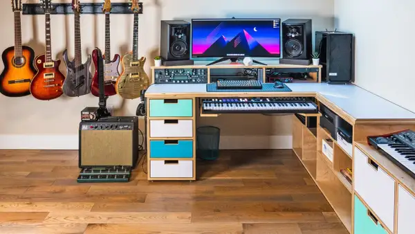 A musician's dream setup for computer music creation, featuring guitars, keyboards, speakers, and a powerful computer.
