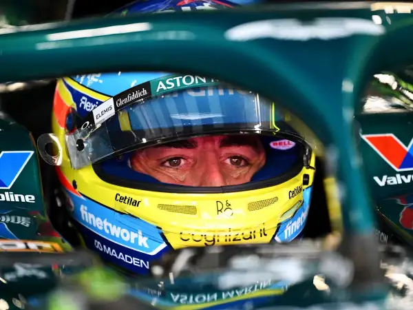 Ojos concentrados de Fernando Alonso con casco Aston Martin, listo para la carrera.