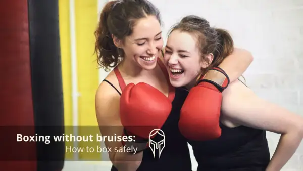 Two women in red boxing gloves laugh during sparing boxing. They are embracing after a friendly match, showing that boxing can be fun and safe.
