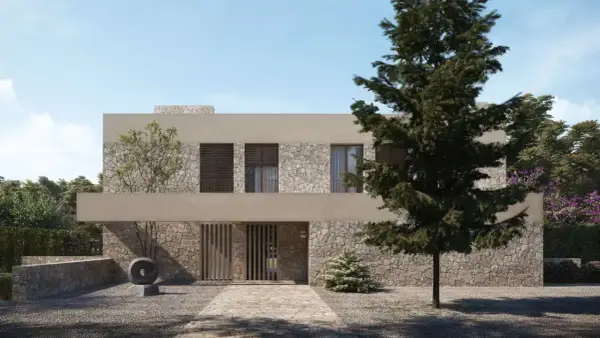 Una casa moderna con fachada de piedra y estuco, ideal para renovar fachada casa. El camino de entrada conduce a una puerta de madera.