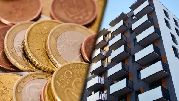 Euro monety i nowoczesny blok mieszkalny. Wpływ stóp procentowych, jak euribor 3m, na rynek nieruchomości.
