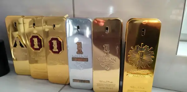 Kolekcja perfum "1 Million" Paco Rabanne, w tym wersje 100ml, błyszczące złote i srebrne flakony w kształcie sztabek.