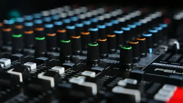 Close-up of a mixing board with colorful knobs, ready to shape sounds like a bitcrusher in FL Studio.