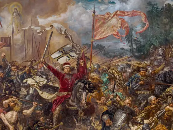 Jan Matejko ukazuje dynamiczną bitwę pod Grunwaldem. W centrum rycerz w czerwieni unosi miecz i chorągiew.