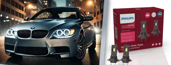 Srebrne auto z włączonymi światłami LED na tle miasta. Obok opakowanie żarówek Philips Ultinon Access, które jakie żarówki odmienią nocną jazdę.