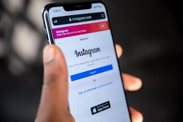 Ktoś trzyma smartfon z otwartą stroną logowania do Instagrama. Czy ktoś widzi, jak oglądam relacje na Instagramie?