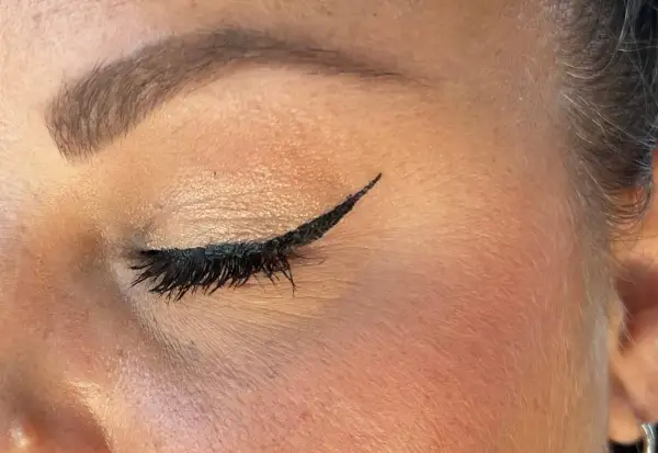 Un trait d'eyeliner noir précis, parfait pour un tuto eyeliner débutant. Cils longs et maquillage des paupières subtil.