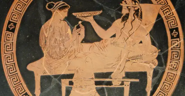Scène antique : une femme, peut-être la femme d'Hadès, offre une coupe à un homme barbu.
