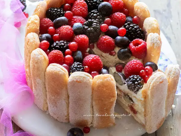 Torta Charlotte ricca di frutti di bosco freschi, con savoiardi croccanti e una crema vellutata. Un dolce estivo perfetto.
