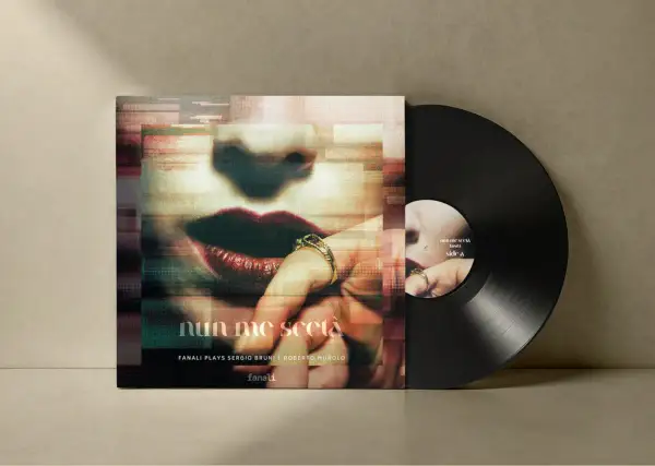 Vinyl record with album cover featuring a close-up of lips and a hand with rings.