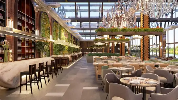 Interior de restaurante moderno con barra, mesas y vegetación. Un lugar así podría costar mucho, pero ¿cuanto cuesta abrir un restaurante?