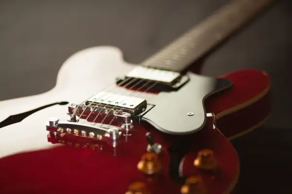 Czerwona gitara elektryczna, idealna do grania metalu, z błyszczącym korpusem i chromowanymi elementami.