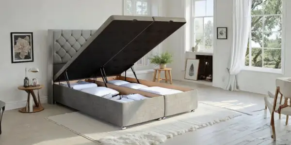 A divan bed with its storage compartments open, revealing neatly folded linens. This versatile divan offers ample hidden storage.