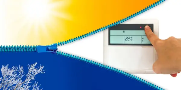 Un doigt appuie sur un thermostat affichant 22°C, symbolisant le contrôle du climat. Une fermeture éclair bleue sépare un soleil éclatant d'un paysage hivernal givré.