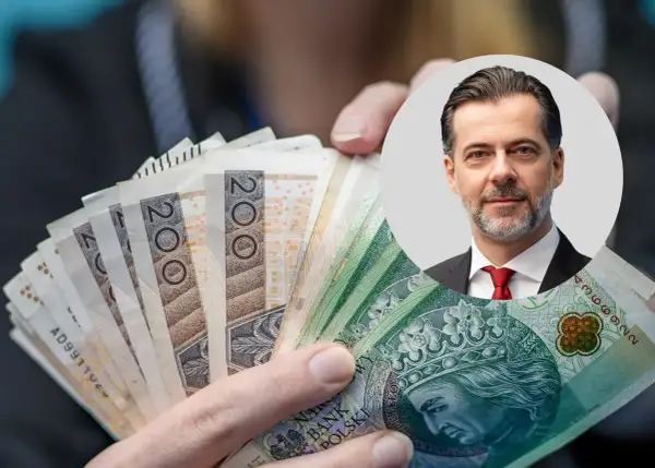 Czy państwo może zabrać pieniądze z konta w razie wojny? Mężczyzna w garniturze trzyma banknoty 200 zł.