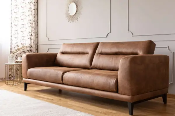 A stylish brown leather sofa, perfect for any living room. Learn how to clean leather furniture to keep it looking its best.