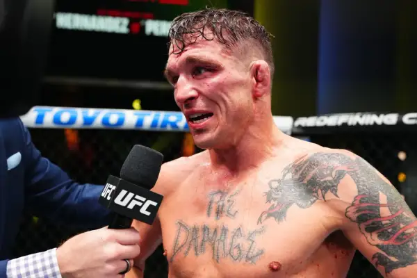 A bloodied fighter, interviewed post-fight, shows the "md" in boxing is the damage taken. His chest tattoo reads "THE DAMAGE".