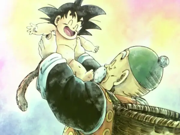 Opa Gohan hält den kleinen Son Gohan hoch. Der Junge lacht und sein Affenschwanz baumelt.