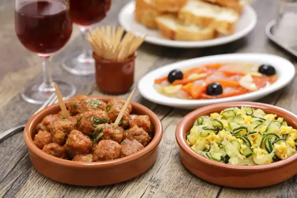 A delicious spread of albondigas españolas, tapas, and wine, perfect for a Spanish feast.