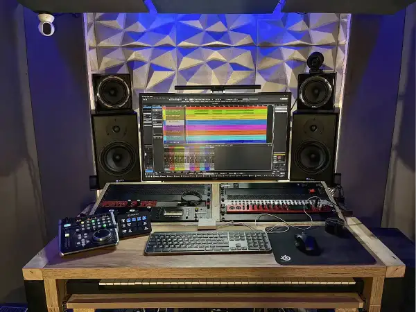 Profesjonalne studio nagraniowe z monitorem odsłuchowym, klawiaturą, kontrolerami i sprzętem do miks mastering.