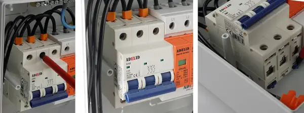 W skrzynce elektrycznej widać bezpieczniki w domu, przewody i wyłączniki.