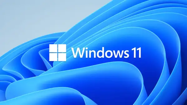 Logo Windows 11 na tle falujących, niebieskich kształtów. Czekasz na aktualizacje Windows 11?