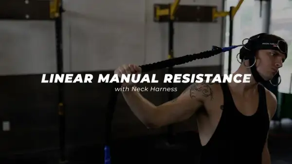 Man using a neck harness for linear manual resistance training, working neck muscles.