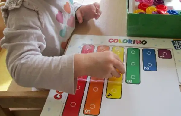 Ein Kind lernt im Kindergarten spielerisch Formen und Farben mit dem Spiel "Colorino".