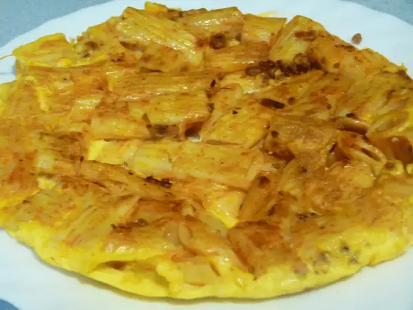 Tortilla de macarrones dorada y apetitosa, con trozos de pasta integrados en el huevo. ¡Un plato casero perfecto!